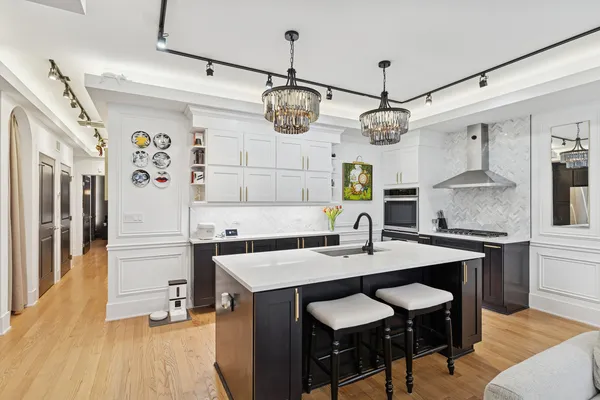 a kitchen with a table chairs and white cabinets