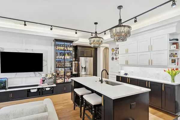 a view of a dining room with furniture a chandelier and wooden floor