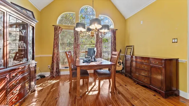 a kitchen with stainless steel appliances granite countertop a stove a sink dishwasher and cabinets with wooden floor