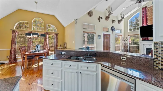 a bedroom with a bed and a chandelier fan