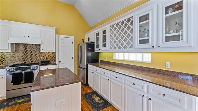 a spacious bedroom with a bed and a chandelier
