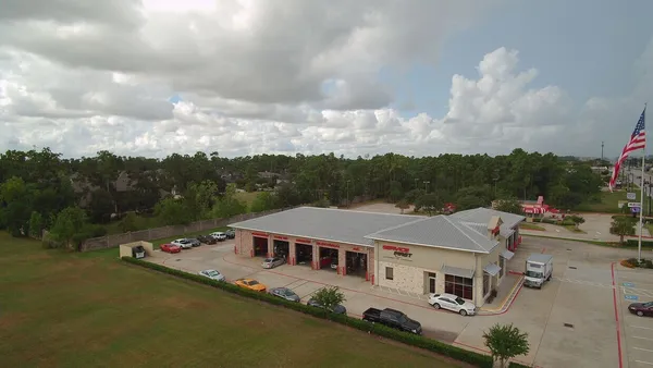 an aerial view of residential houses with outdoor space and lakeside