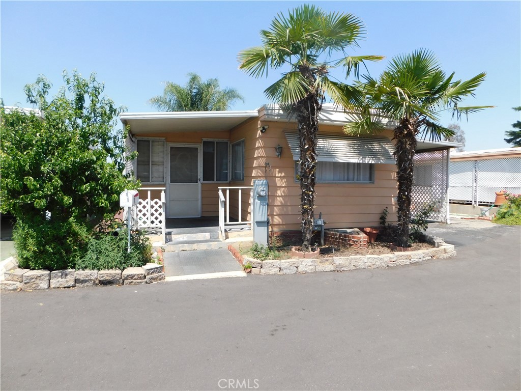 a view of a house with palm trees