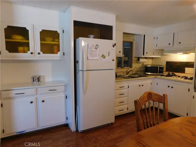 a kitchen with stainless steel appliances a refrigerator sink and cabinets