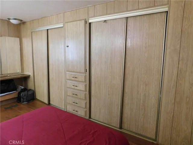 a bedroom with a bed and a closet