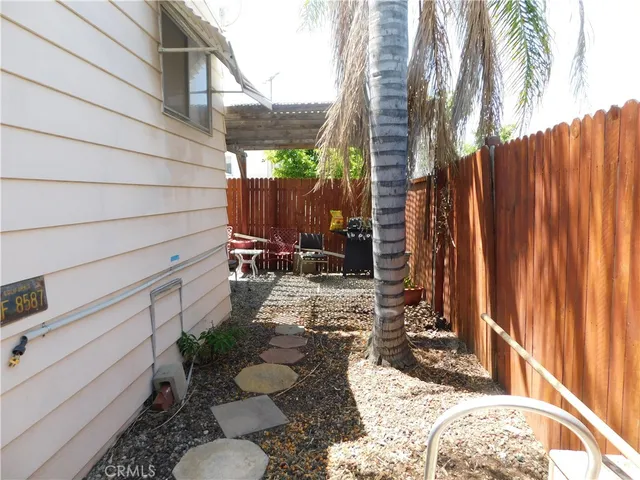 a view of a backyard with sitting area
