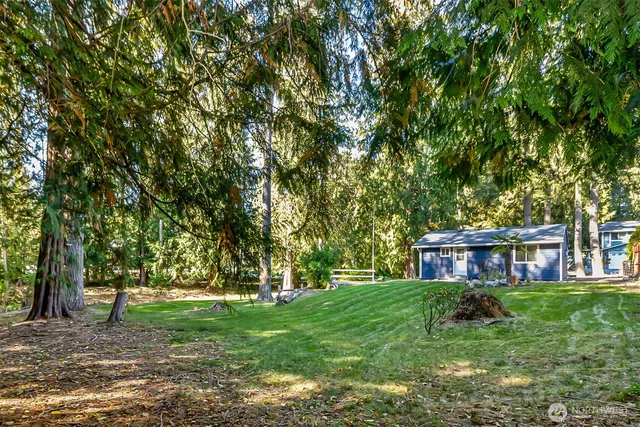 a view of house with a yard