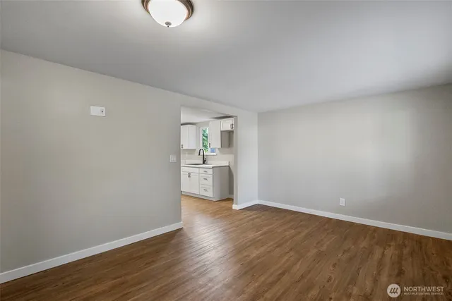 a view of a kitchen with wooden floor