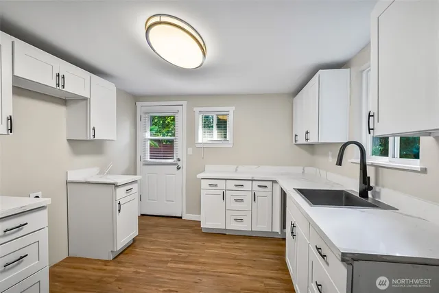 a kitchen with a stove a sink and a refrigerator