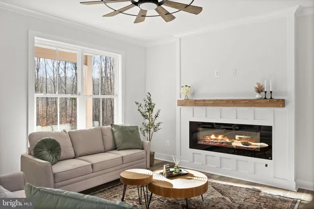 a living room with furniture a fireplace and a large window