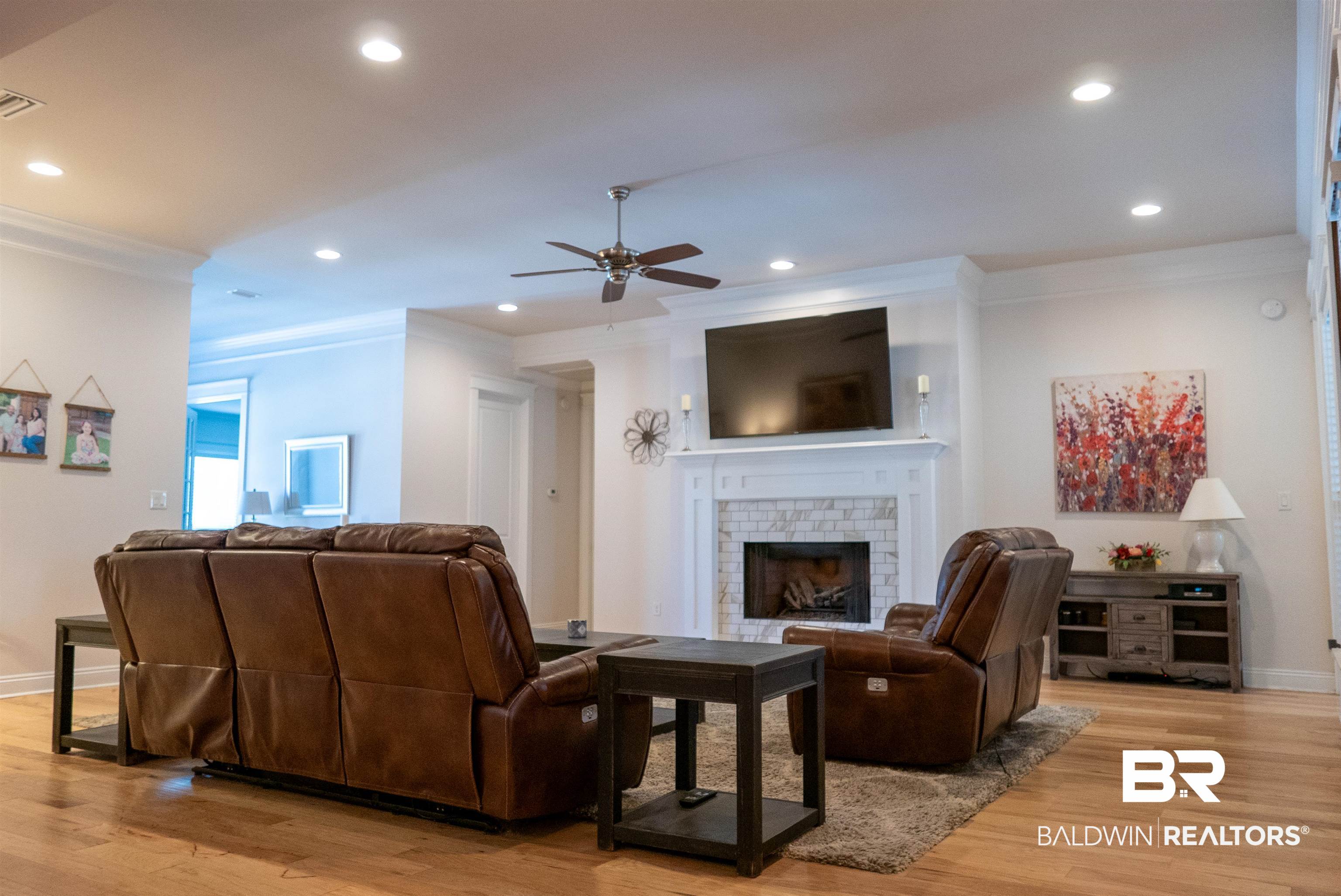 6684 Garrison Drive Daphne, AL 36527 - Photo 8 of 35 Living room featuring ornamental molding, a fireplace, light hardwood / wood-style floors, and ceiling fan