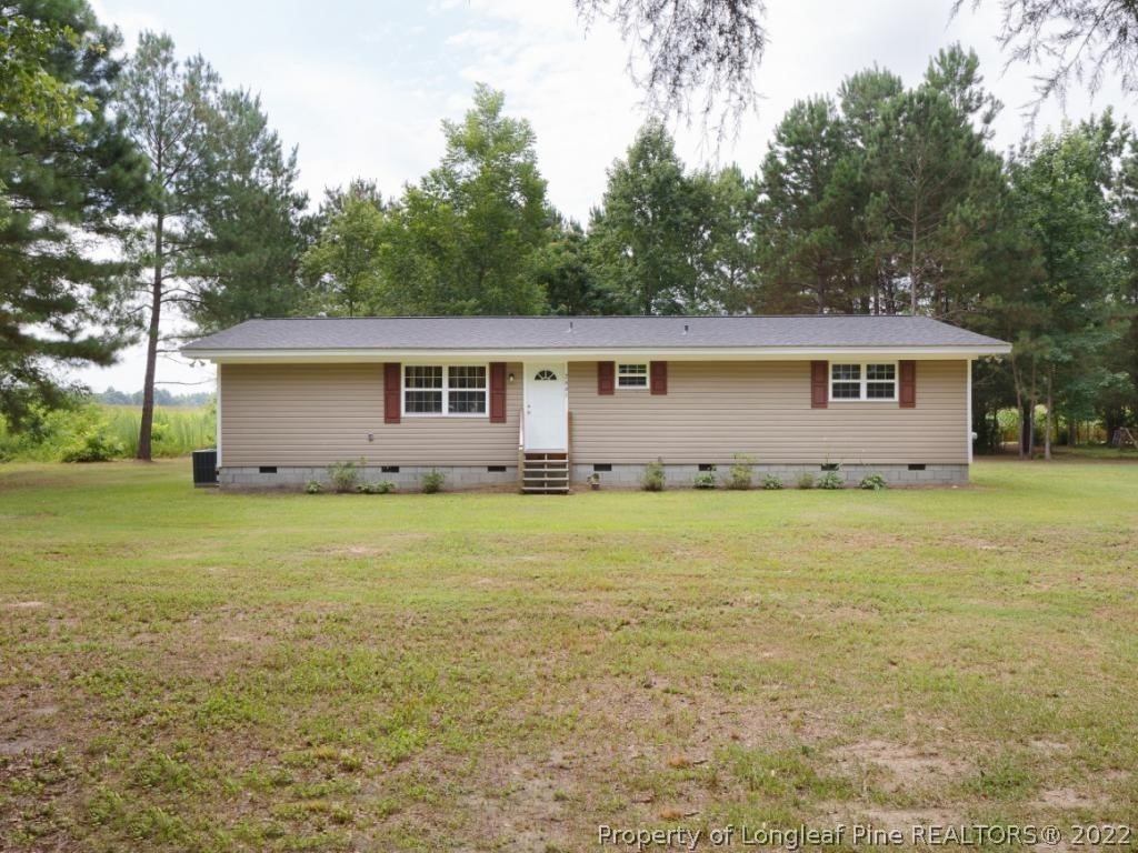 7661 Rufus Johnson Road, Unit 2 Fayetteville, NC 28306 - Photo 1 of 14 a view of a house with a garden