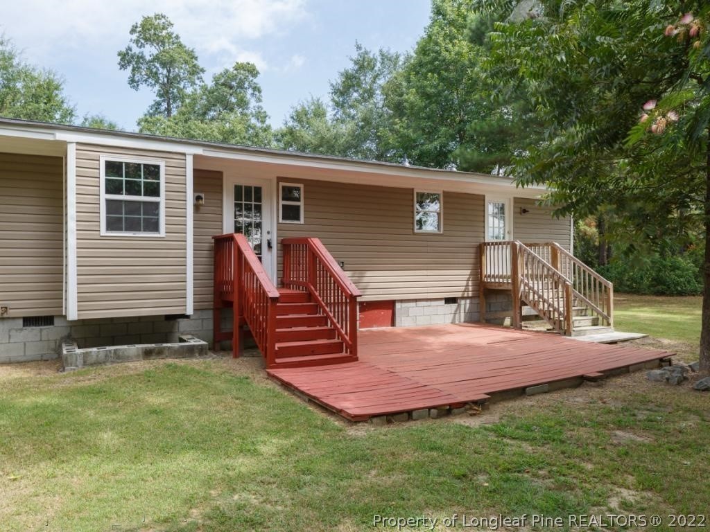 7661 Rufus Johnson Road, Unit 2 Fayetteville, NC 28306 - Photo 13 of 14 a view of a house with backyard and a tree