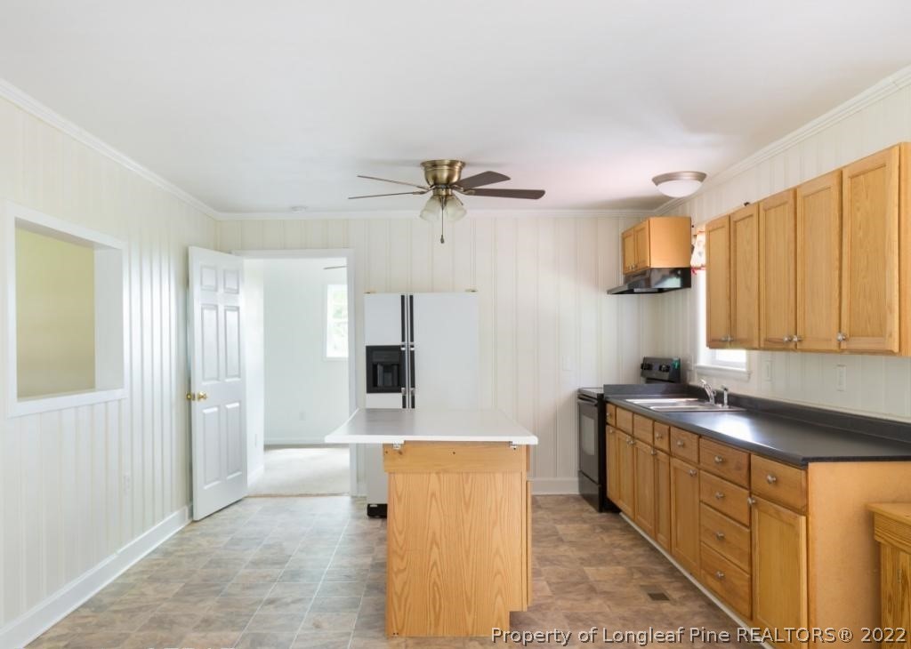 7661 Rufus Johnson Road, Unit 2 Fayetteville, NC 28306 - Photo 5 of 14 a kitchen with stainless steel appliances granite countertop a sink stove and refrigerator