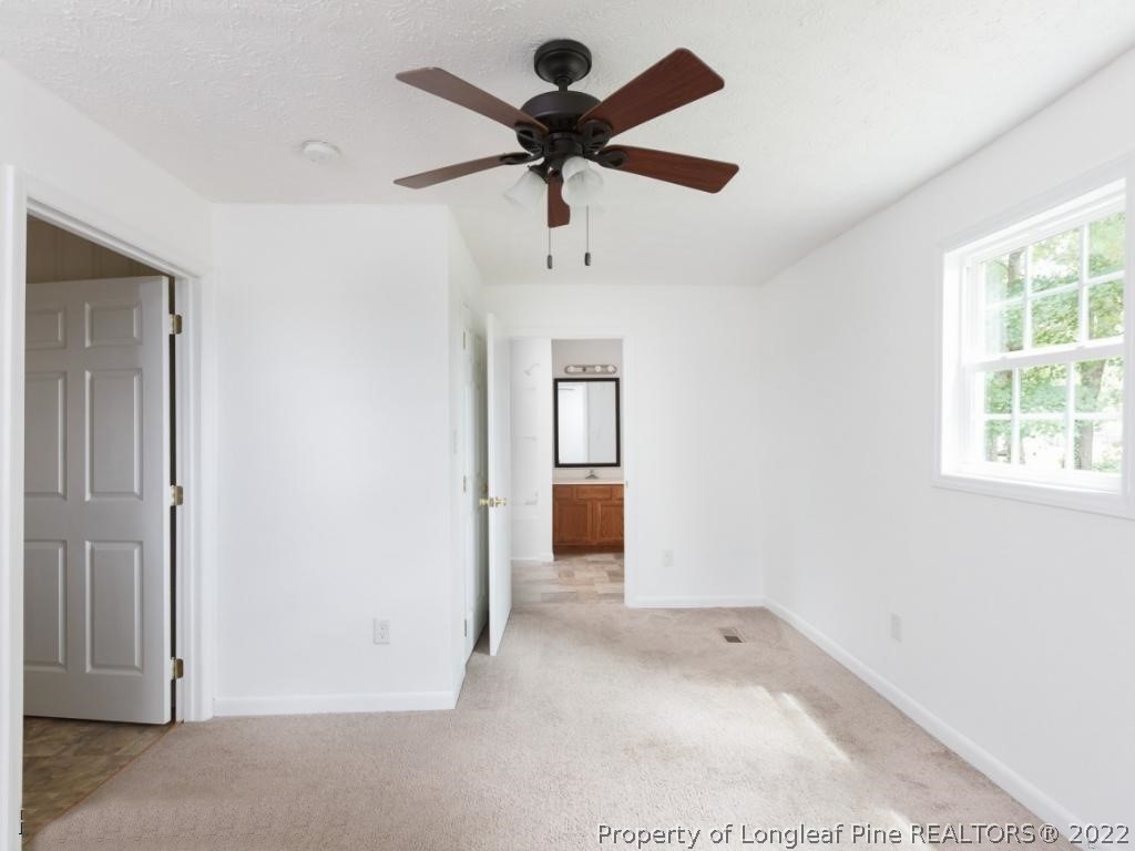 7661 Rufus Johnson Road, Unit 2 Fayetteville, NC 28306 - Photo 6 of 14 a view of empty room with ceiling fan