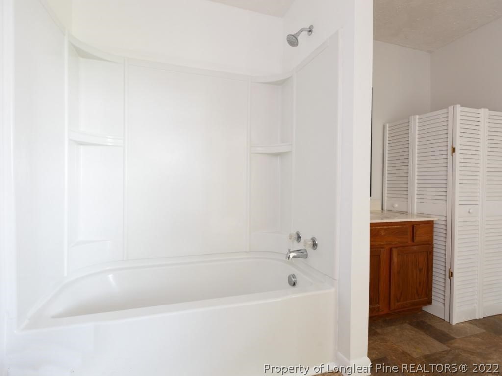 7661 Rufus Johnson Road, Unit 2 Fayetteville, NC 28306 - Photo 7 of 14 a bathroom with a bathtub
