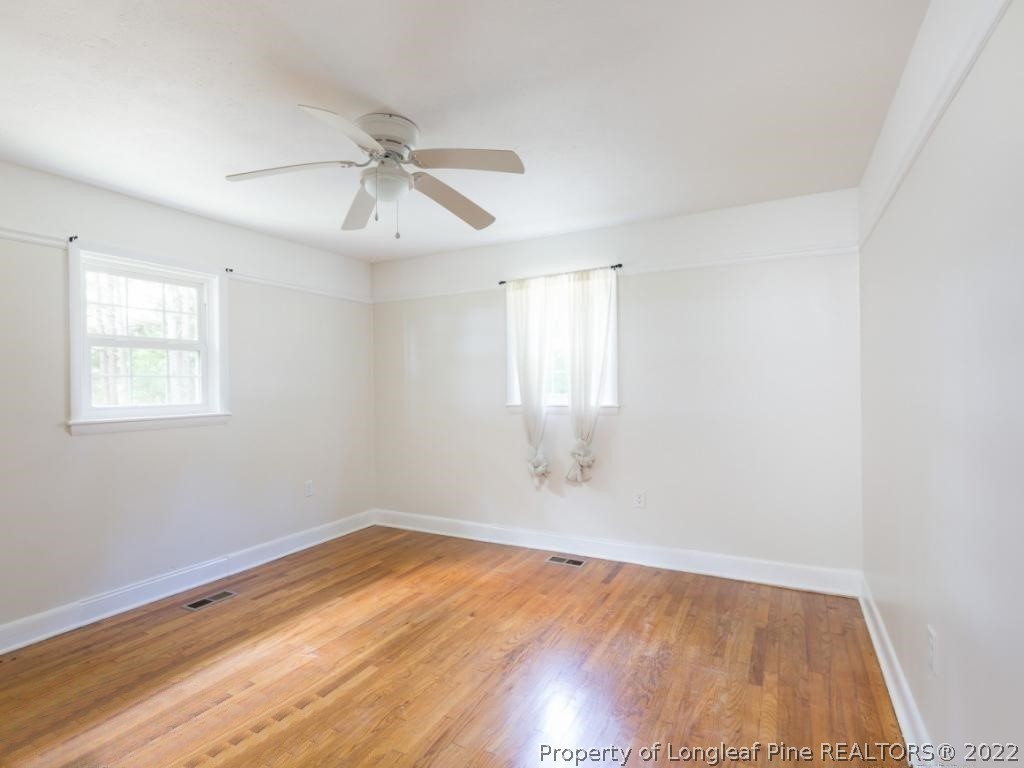 7661 Rufus Johnson Road, Unit 2 Fayetteville, NC 28306 - Photo 8 of 14 wooden floor in an empty room with a window