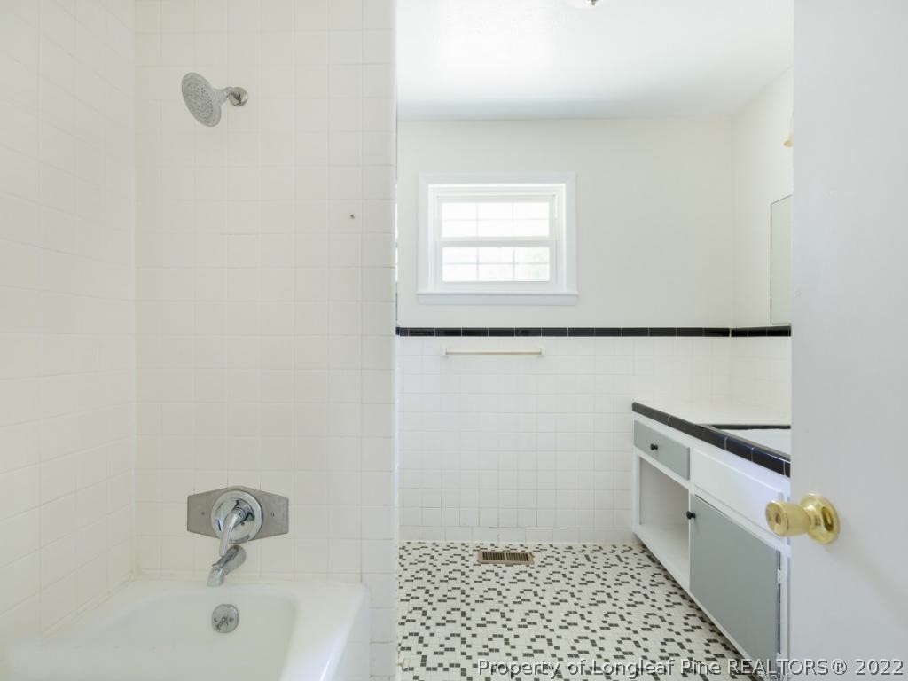 7661 Rufus Johnson Road, Unit 2 Fayetteville, NC 28306 - Photo 10 of 14 a bathroom with a bathtub and shower