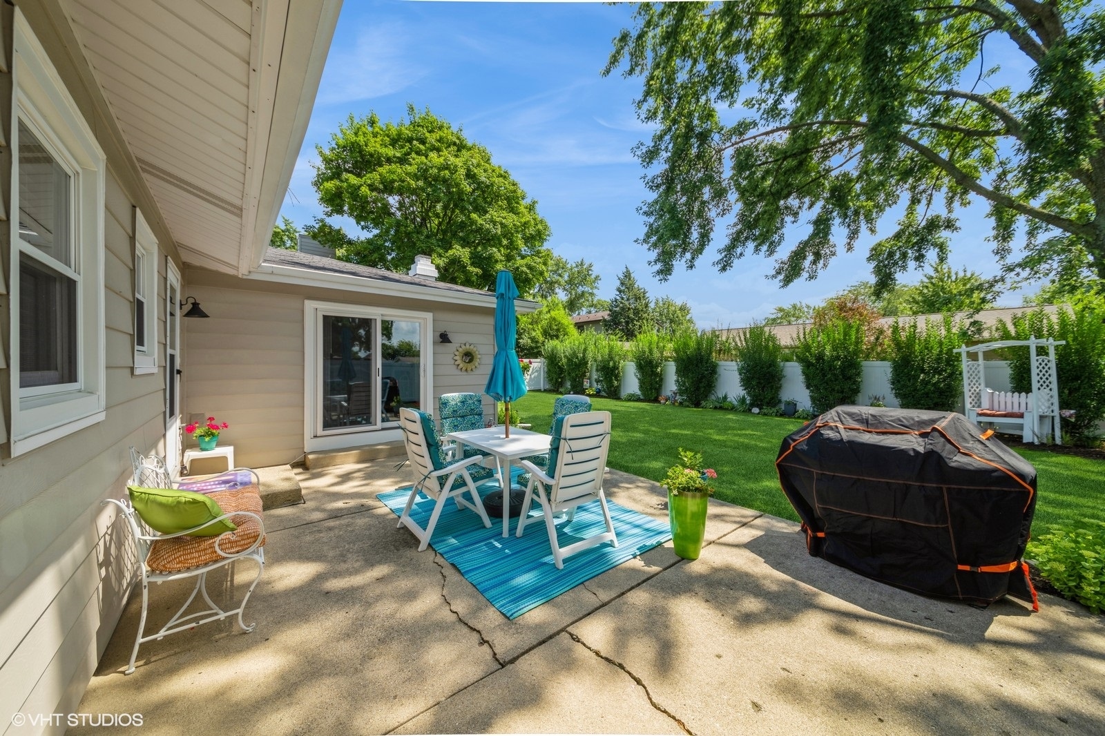 339 Yarmouth Road Elk Grove Village, IL 60007 - Photo 33 of 40 a view of a patio with table and chairs potted plants and a palm tree
