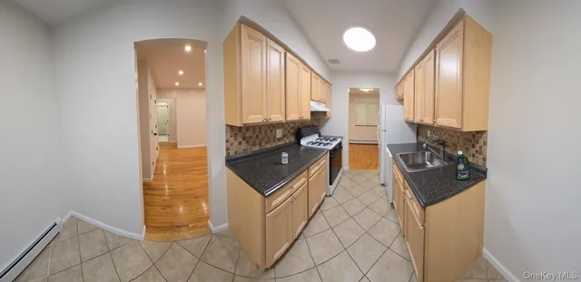 a kitchen with granite countertop a sink and a stove top oven