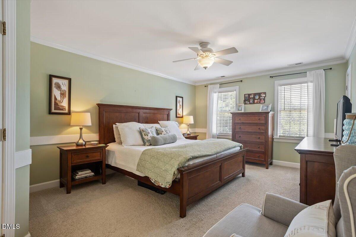 1808 Thorpshire Drive Raleigh, NC 27615 - Photo 9 of 17 a bedroom with a bed and a chandelier