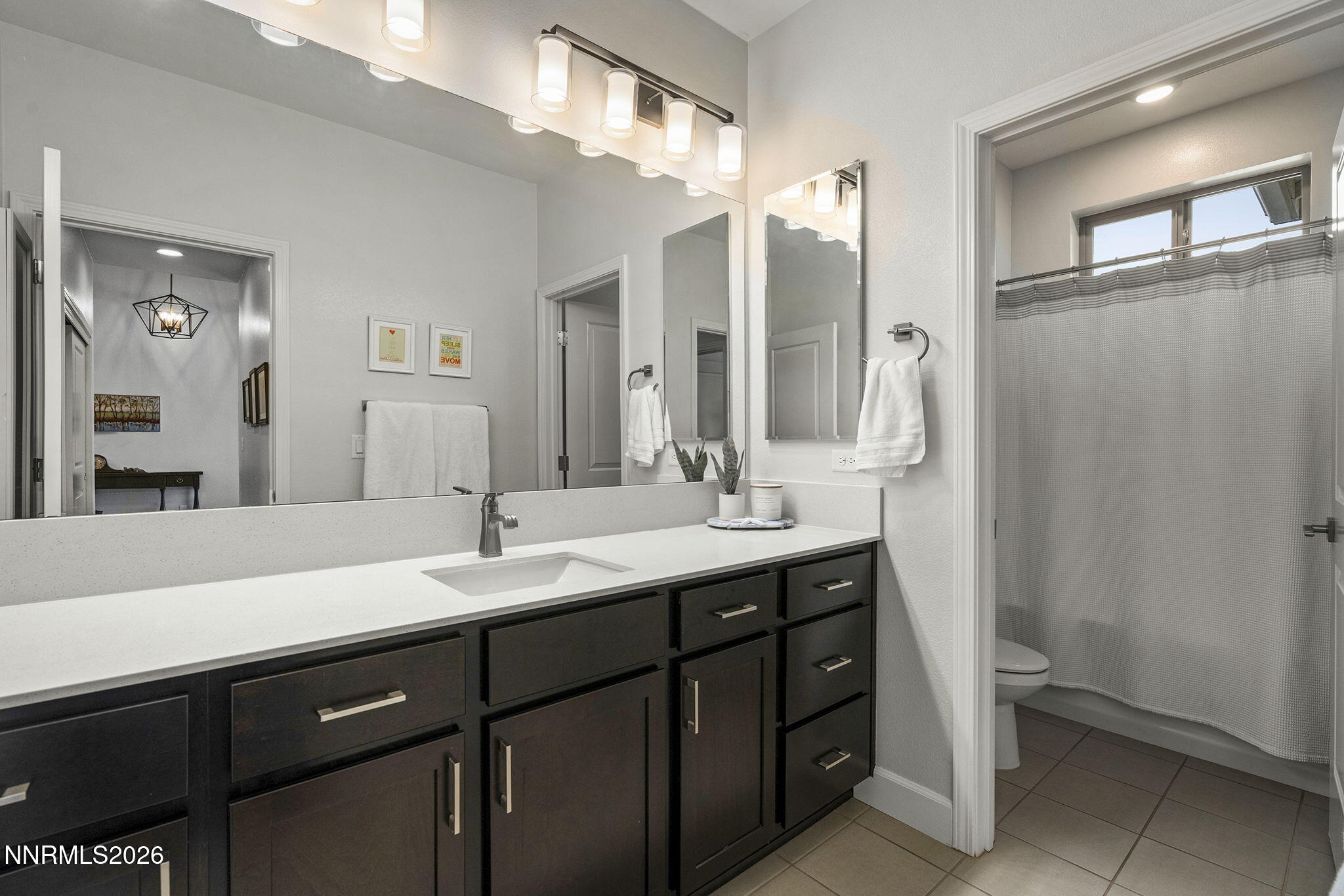 531 Riverbed Circle Reno, NV 89521 - Photo 17 of 32 a bathroom with a double vanity sink and mirror