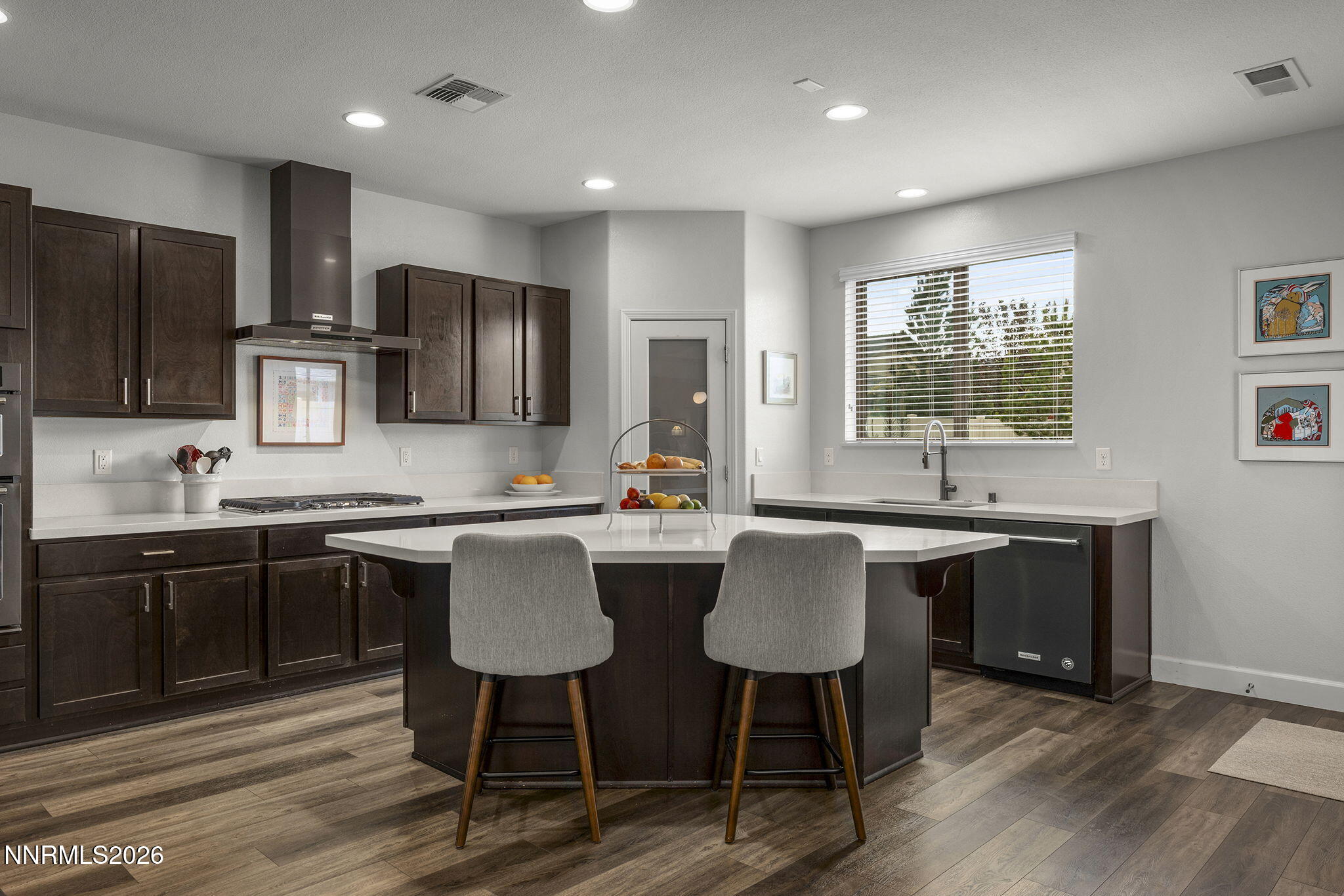 531 Riverbed Circle Reno, NV 89521 - Photo 3 of 32 a kitchen with stainless steel appliances granite countertop a sink a stove a refrigerator cabinets and chairs