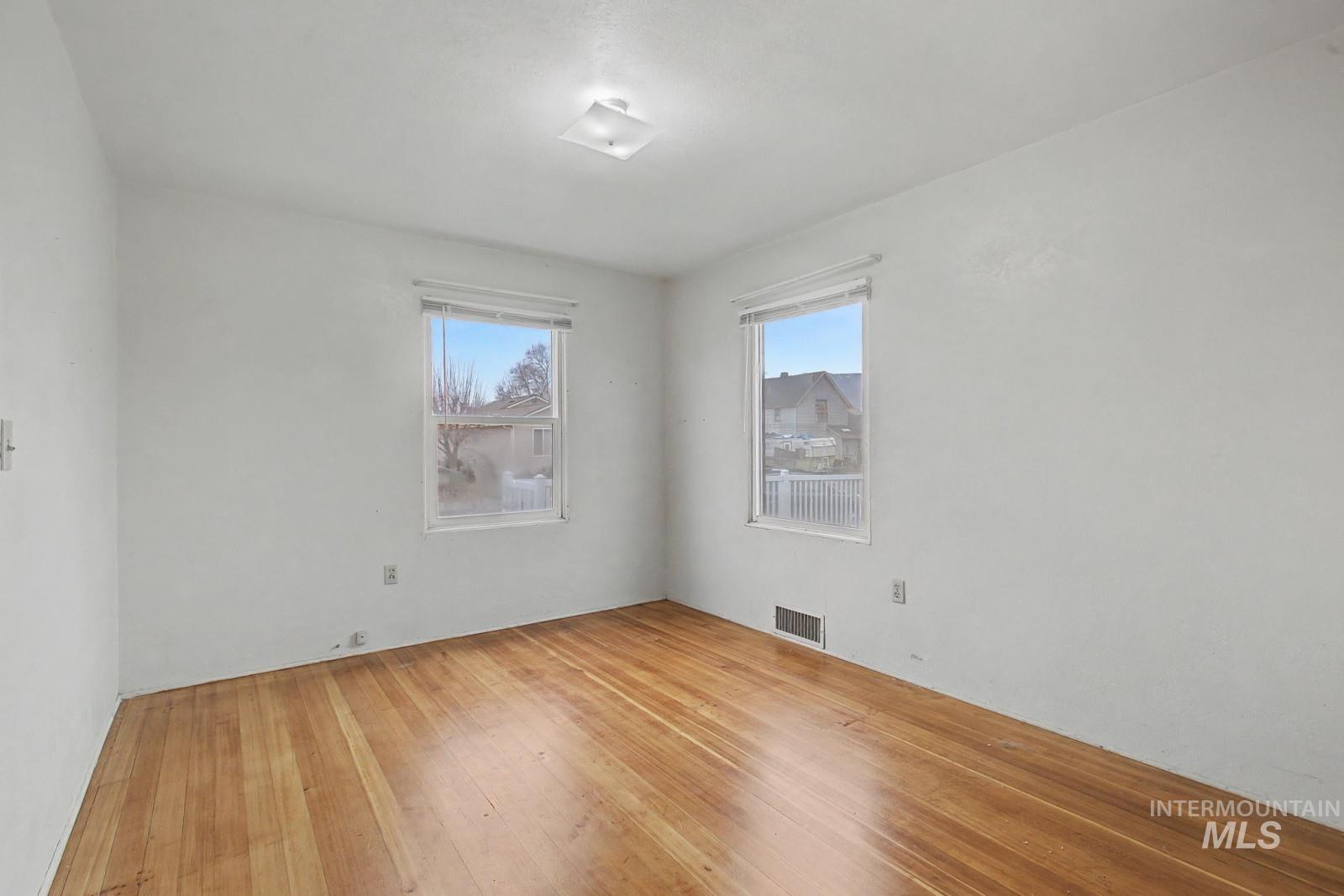 918 Elm Street Clarkston, WA 99403 - Photo 12 of 35 Empty room featuring hardwood / wood-style floors