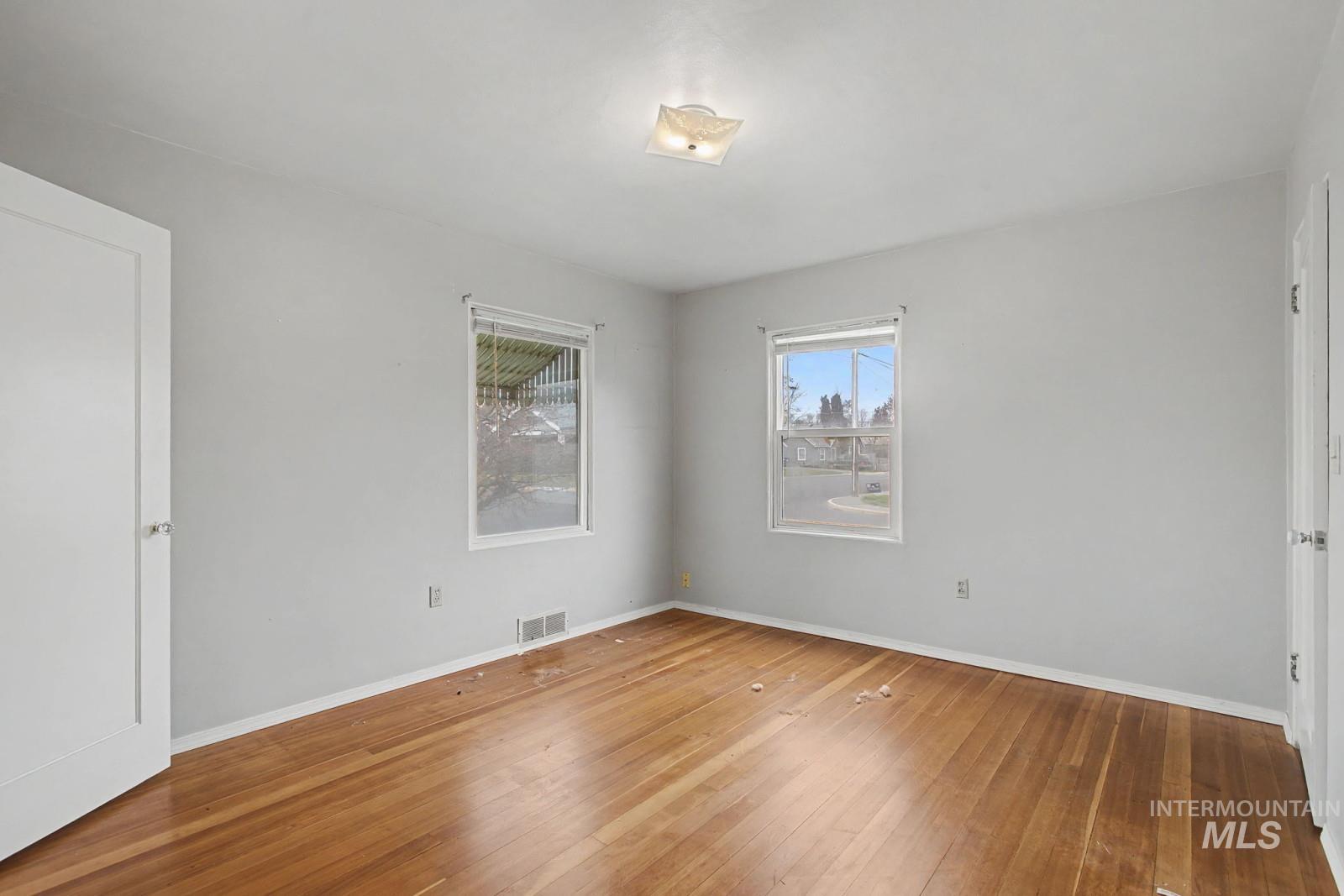 918 Elm Street Clarkston, WA 99403 - Photo 14 of 35 Spare room featuring hardwood / wood-style flooring and baseboards