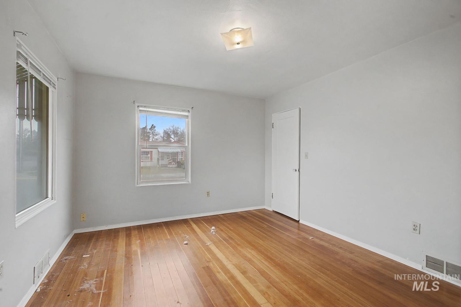 918 Elm Street Clarkston, WA 99403 - Photo 15 of 35 Empty room with hardwood / wood-style floors and baseboards