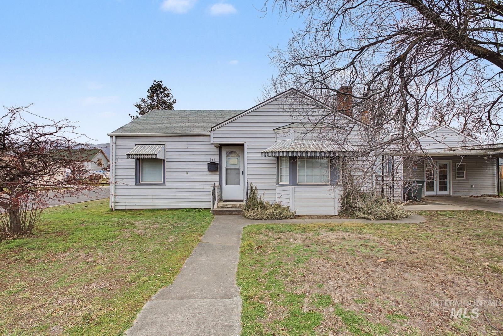 918 Elm Street Clarkston, WA 99403 - Photo 28 of 35 Bungalow-style home with a front yard, a chimney, a carport, and a shingled roof