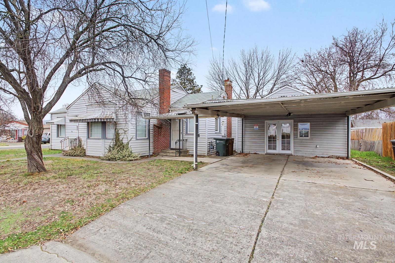 918 Elm Street Clarkston, WA 99403 - Photo 29 of 35 View of front of house with driveway, french doors, a chimney, and an attached carport