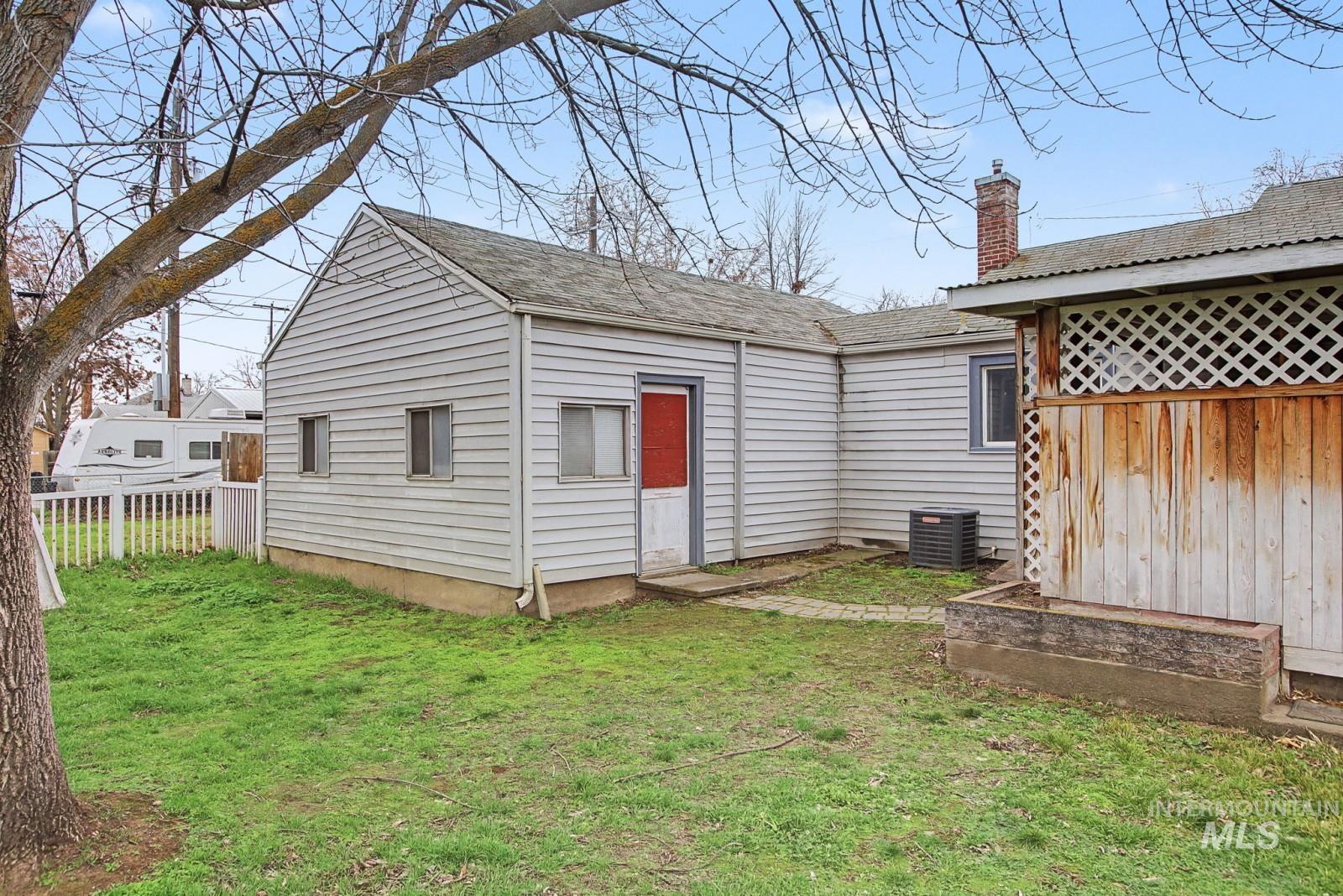 918 Elm Street Clarkston, WA 99403 - Photo 32 of 35 Rear view of house with a chimney and a shingled roof