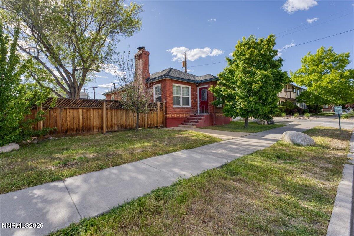 1025 Locust Street Reno, NV 89502 - Photo 23 of 28 a front view of a house with a yard and a large tree