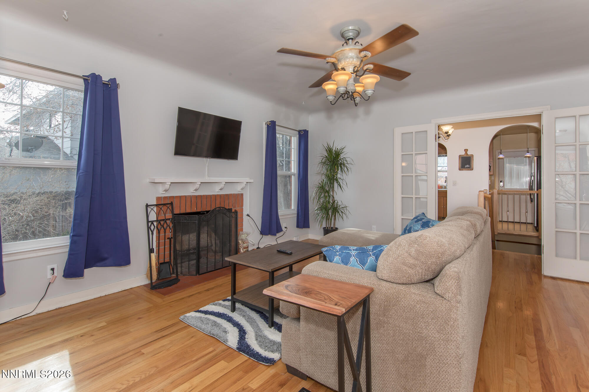 1025 Locust Street Reno, NV 89502 - Photo 4 of 28 a living room with furniture a fireplace and a flat screen tv