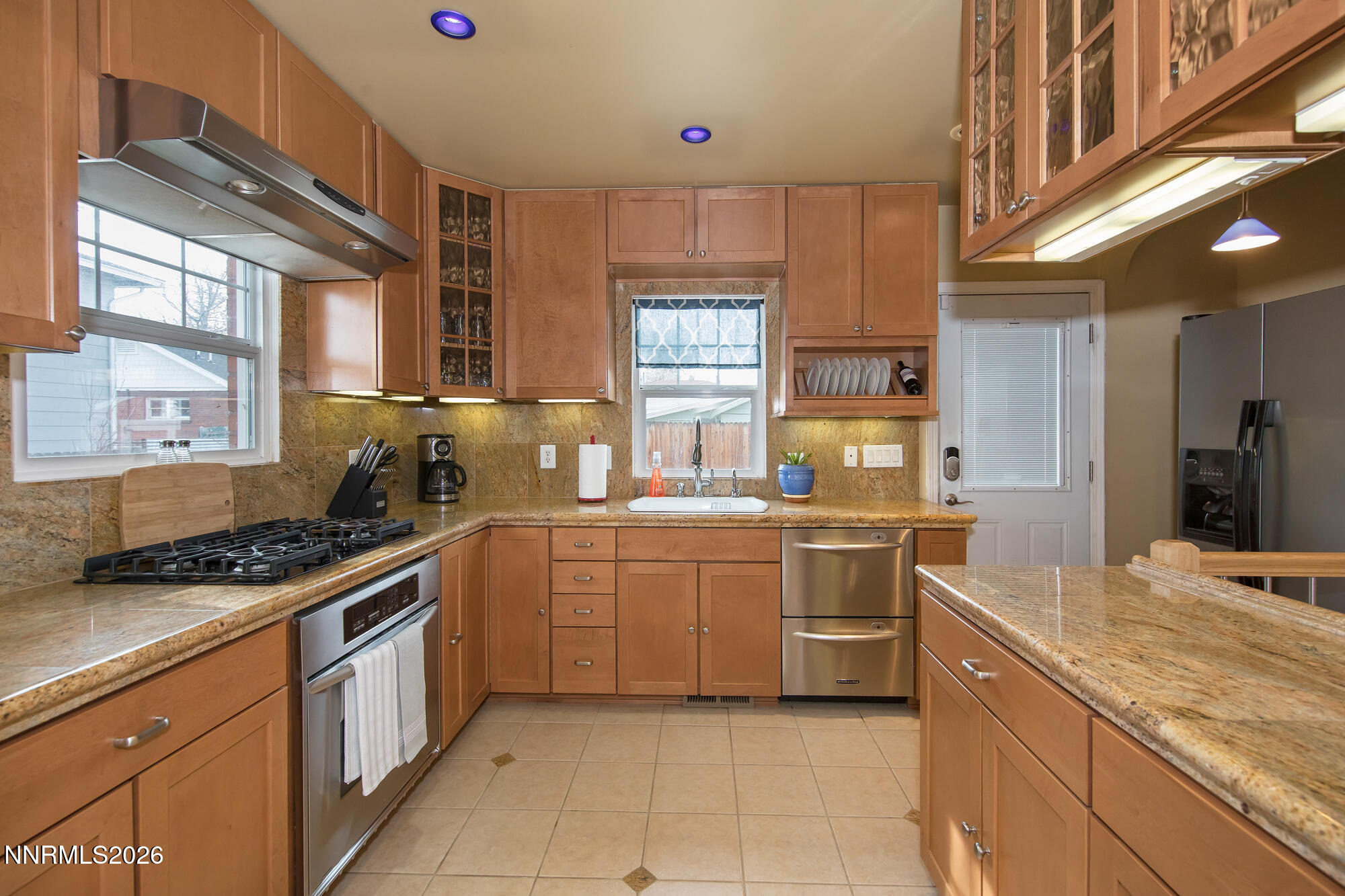1025 Locust Street Reno, NV 89502 - Photo 6 of 28 a kitchen with stainless steel appliances granite countertop a stove a sink dishwasher and a refrigerator
