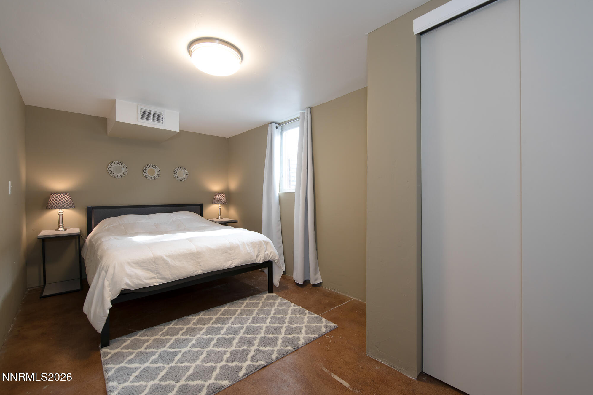 1025 Locust Street Reno, NV 89502 - Photo 8 of 28 a bedroom with a bed and a night stand