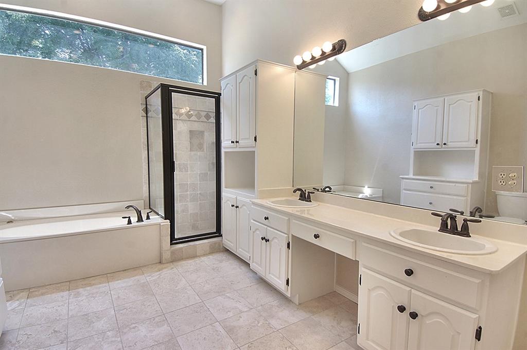 5806 Smoke Glass Trail Dallas, TX 75252 - Photo 16 of 35 a spacious bathroom with a double vanity sink mirror double and bathtub