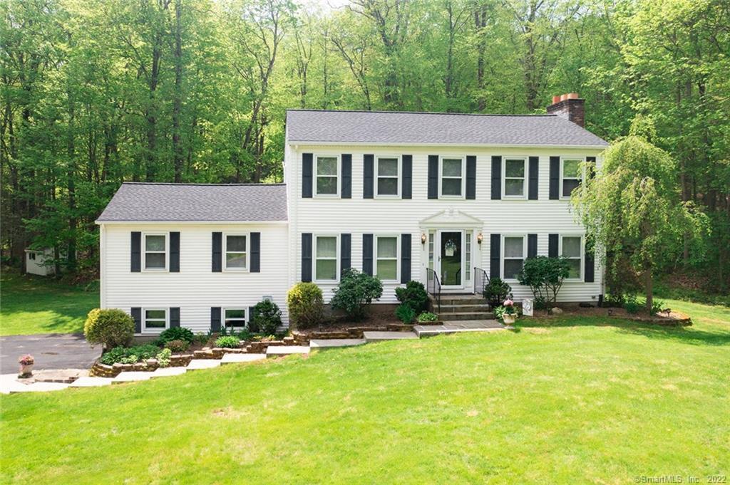 17 Rolling Ridge Court Prospect, CT 06712 - Photo 1 of 1 a front view of a house with a yard table and chairs