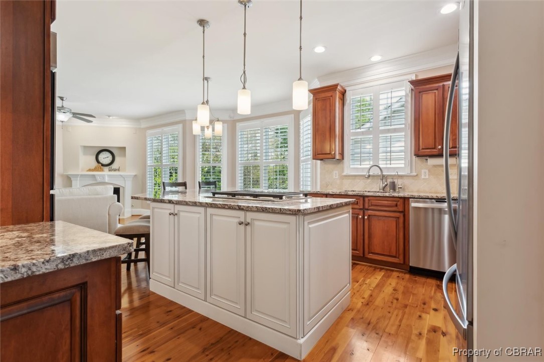 3013 Ridge Drive Toano, VA 23168 - Photo 50 of 50 Kitchen with light wood finished floors, open floor plan, a kitchen island, and appliances with stainless steel finishes