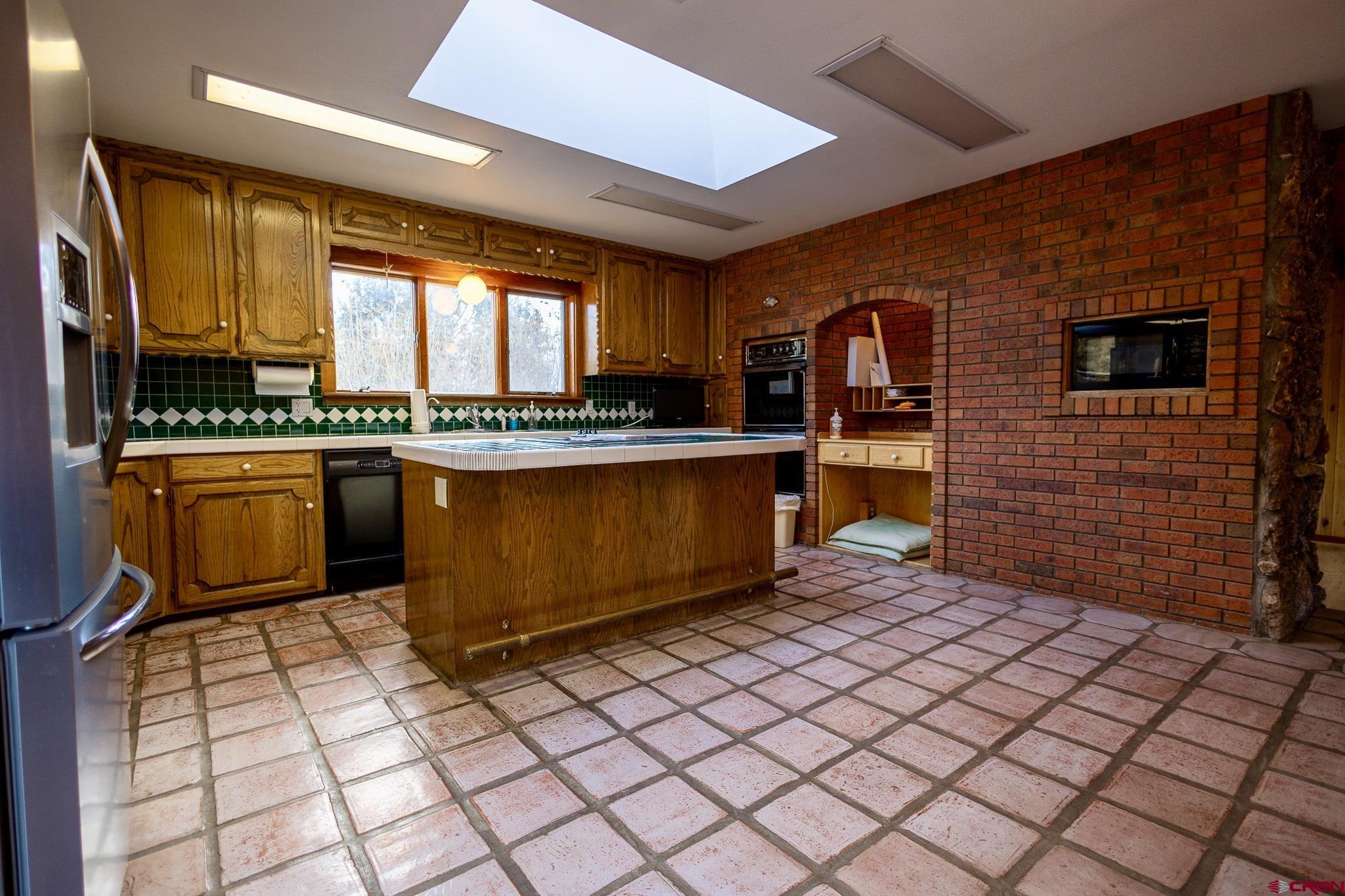 301 Tree Farm Drive Basalt, CO 81621 - Photo 14 of 35 a kitchen with stainless steel appliances granite countertop a stove a sink and a microwave