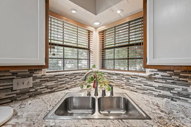 a kitchen with granite countertop a sink and a window