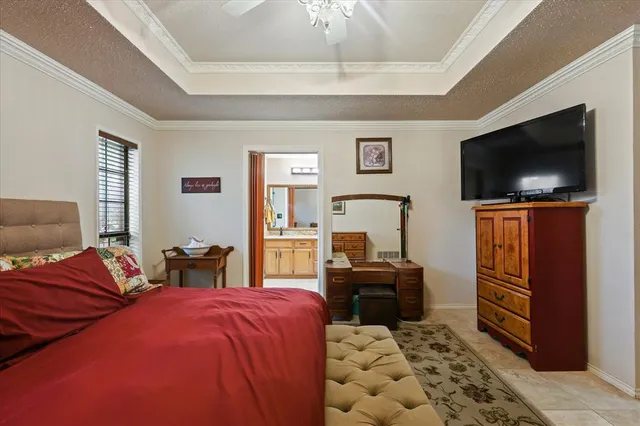 a bedroom with furniture and a flat screen tv