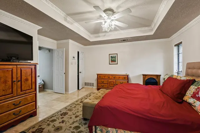 a bedroom with furniture and a flat screen tv