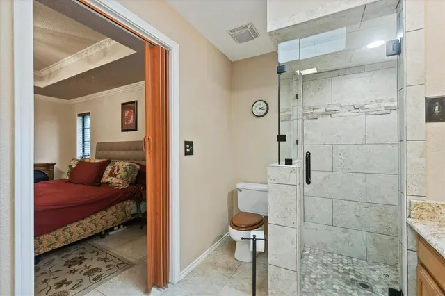 a view of a bedroom with a bed and wooden floor