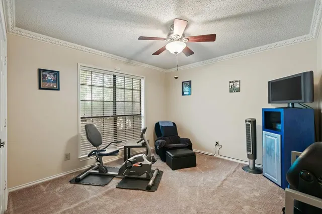 a view of a livingroom with workspace and a window