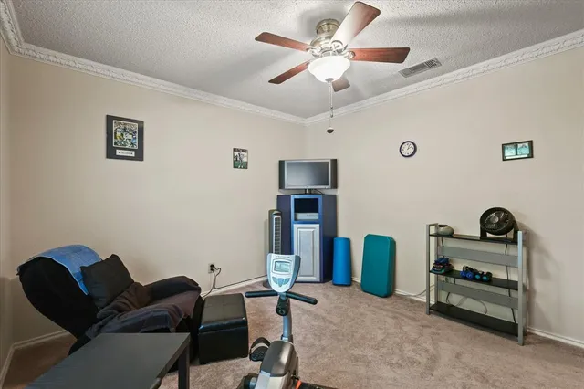 a workspace with furniture and ceiling fan