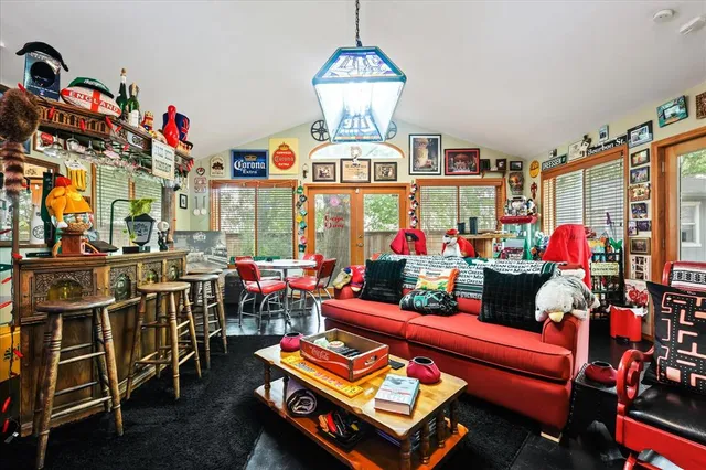 a bedroom with furniture and a large window