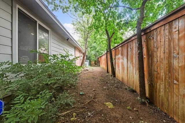 a view of a chairs and table in the back yard of the house