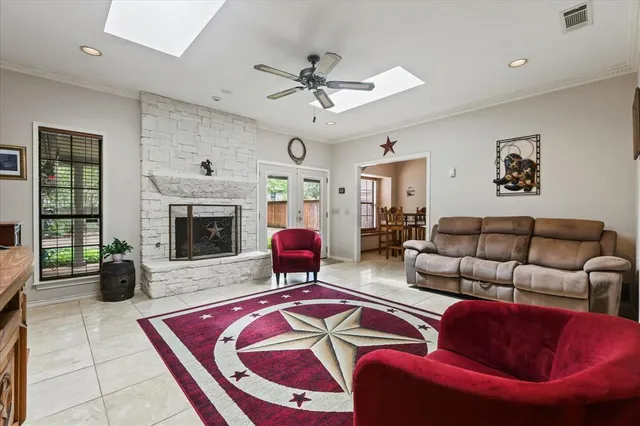 a living room with furniture a fireplace and a chandelier